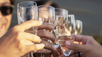 Group of happy friends drinking and toasting champagne outdoors in the terrace - Friendship concept with young people having fun