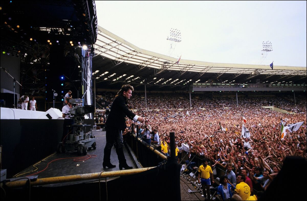 Bono performs on stage during the Live Aid concert at Wembley Stadium on 13 July, 1985 in London, England. Live Aid was watched by millions around the world on television and raised vast quantities of donated money to help relieve a severe famine in Ethiopia. (Photo by Georges De Keerle/Getty Images) Bono performs on stage during the Live Aid concert at Wembley Stadium on 13 July, 1985 in London, England. Live Aid was watched by millions around the world on television and raised vast quantities of donated money to help relieve a severe famine in Ethiopia. (Photo by Georges De Keerle/Getty Images)