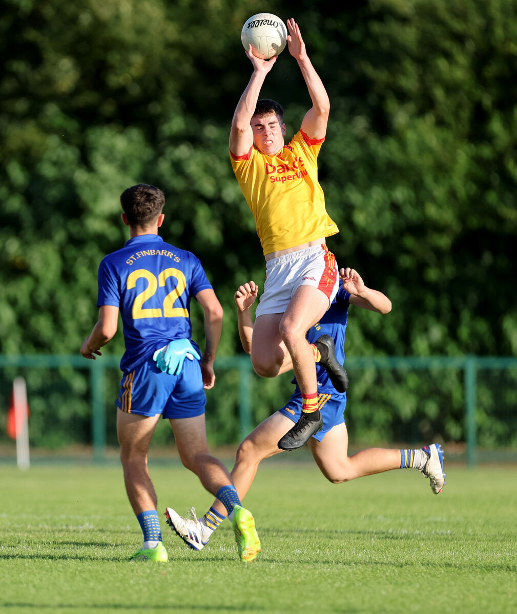  Edmund Burke and CJ Barrett, St. Finbarrs are beaten to the high ball by Darragh Carroll, Mallow. Picture: Jim Coughlan.