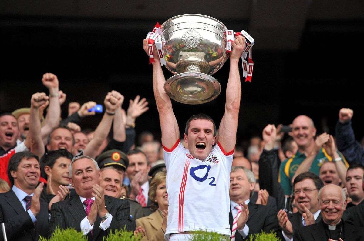Graham Canty - wearing the white Cork change jersey - lifts the Sam Maguire Cup after the All-Ireland SFC final win over Down in 2010. Picture: David Maher/Sportsfile