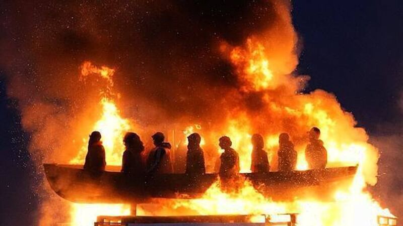 Tyrone bonfire topped with migrant boat effigy is set alight Tyrone bonfire topped with migrant boat effigy is set alight