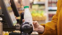 Woman Scanning Groceries at Self Checkout in Supermarket