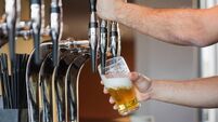Barmans arms pulling a pint of beer