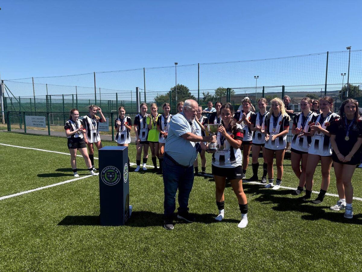 Midleton U17 captain Amy Lyons is presented with the Munster trophy 
