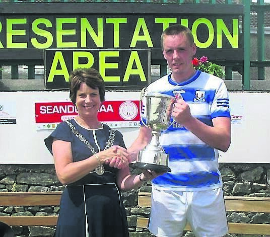 Deputy Lord Mayor Margaret McDonnell presenting the Terence McSwiney Cup to Ballyphehane captain Cian O’Brien.