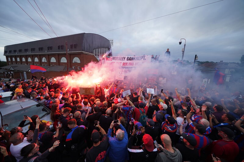 Crystal Palace fans let off flares during a protest march from Norwood Clocktower to Selhurst Park.