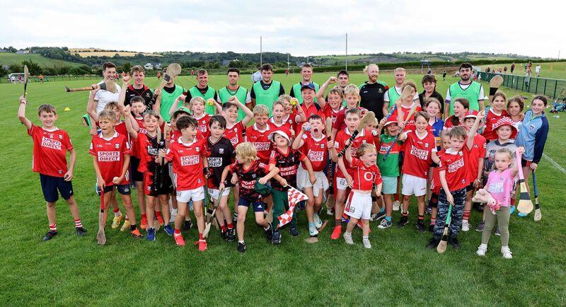  Fr. O'Neills Senior Hurling squad members with young Rebel supporters. Picture: Jim Coughlan.
