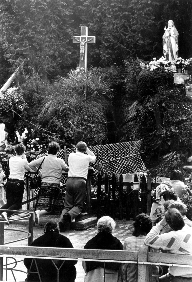 Visitors pray at the grotto that summer Visitors pray at the grotto that summer