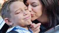 Young boy upset with mom's goodbye kiss at school