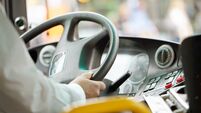 cropped shot of bus driver holding steering whee