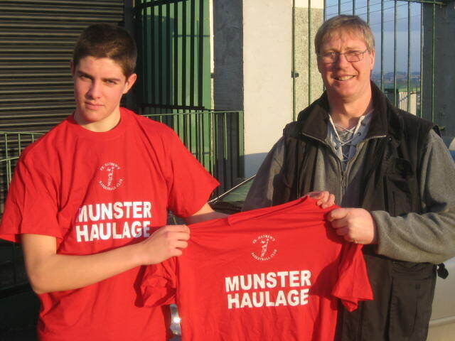 U15 coach Peter Lyall and U15 captain Cian O'Flynn admire their new gear sponsored by Munster Haulage