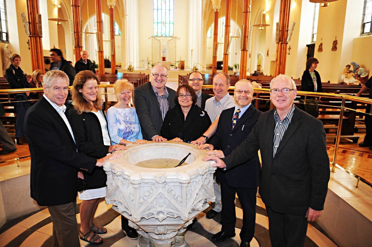 Author and professor Elliott J Gorn, actress Kaiulani Lee, author Marat Moore, Jim Fitzpatrick of the Cork Mother Jones Committee, author and film maker Prof Rosemary Feurer, Brian McGee of the Cork Archives, and Gerard O’Mahony, Richard T Cooke, and Ted Tynan of the Cork Mother Jones Committee, at the inaugural Spirit of Mother Jones Festival, gathered around the baptism font in the North Cathedral where Mary Harris was baptised on August 1, 1837.	Picture: Martin Duggan
                    