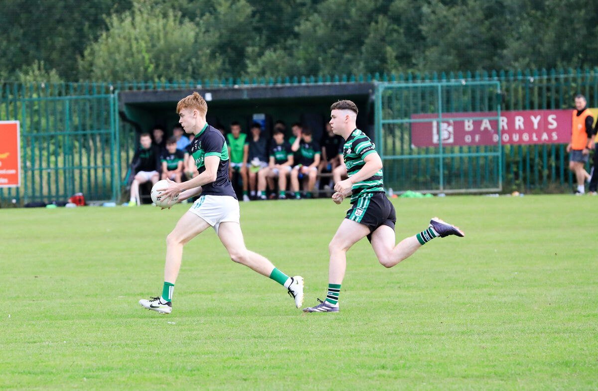 Nemo's Matthew Keenan breaks away from Douglas player Darragh O'Connor. Picture: David Creedon