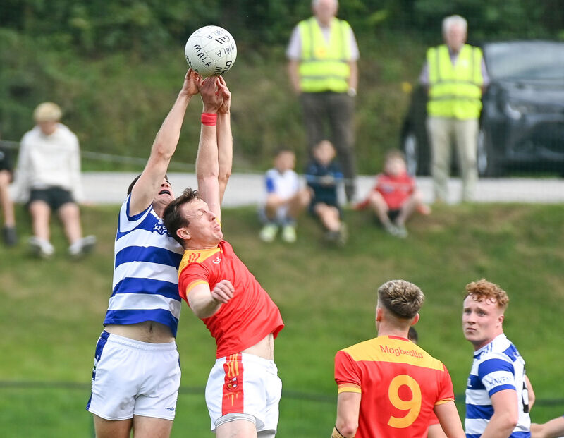 Castlehaven's Andrew Whelton and Mallow's Michael O'Rourke compete in the air at Ovens. Picture: David Keane. Castlehaven's Andrew Whelton and Mallow's Michael O'Rourke compete in the air at Ovens. Picture: David Keane.