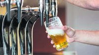 Barmans arms pulling a pint of beer