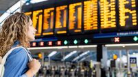 Traveler at the airport looking at the arrival departure board