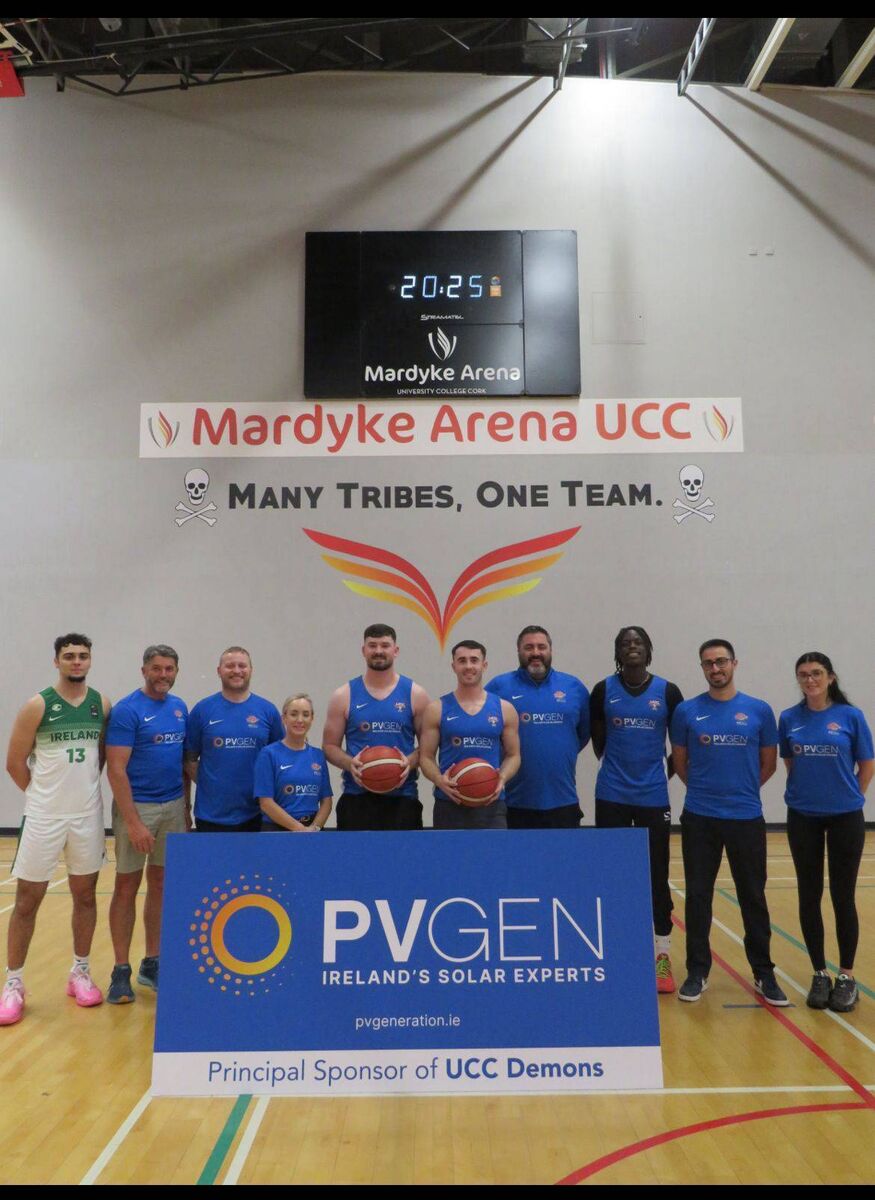 Laura McCardle and Joe Garvin of PV Gen with UCC Demons players and coaching staff at the launch in the Mardyke Arena
