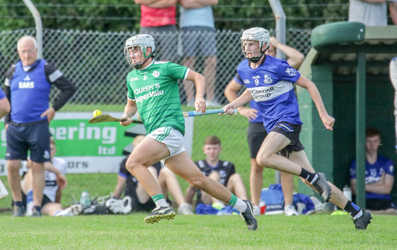 Ballincollig's Joe Miskella is chased by Sarsfields' Josh McNamara. Picture: David Creedon