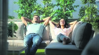 Couple relaxing on a couch in a terrace