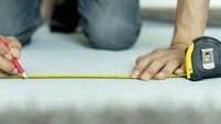 measuring carpet on floor