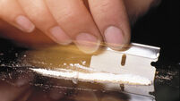 Cutting Line of Cocaine with Razor Blade