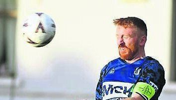 Crosshaven’s James Kind heads the ball clear during the junior Super Cup final last season.