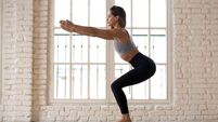Young attractive yogi woman practicing yoga, Utkatasana pose