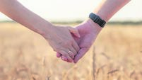 A couple holding hand during sunset, a symbol of love and happy