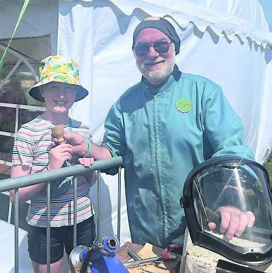 Maureen Cogan, Mallow, presented with an egg cup by Gerard Dubois, Carrigaline Men’s Shed, who had just turned and polished it on the lathe at the Roberts Cove Vintage Festival.