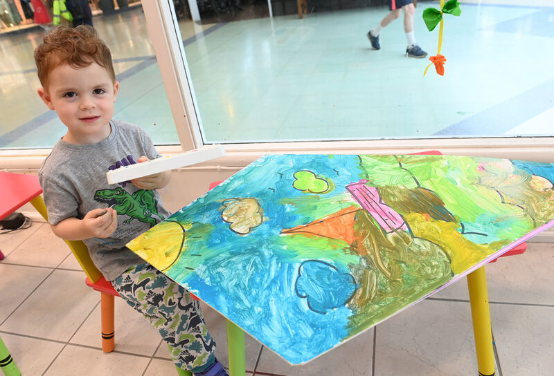  Alex busy decorating his kite at the Kite Festival HQ at Douglas Court Shopping Centre.