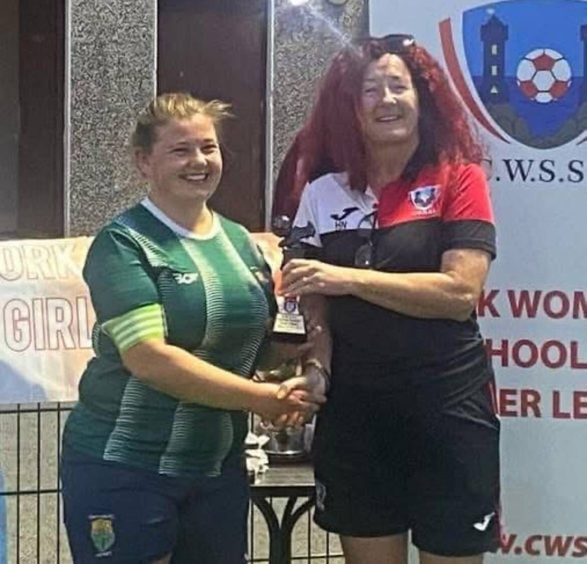Macroom's Lauren Manning receives the POTM at the recent Kevin Barry Cup final from the CWSSL's Helen Noonan