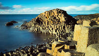 Sunny afternoon and calm waters on the famous Giant's Causeway on the Antrim Coast of Northern Ireland
