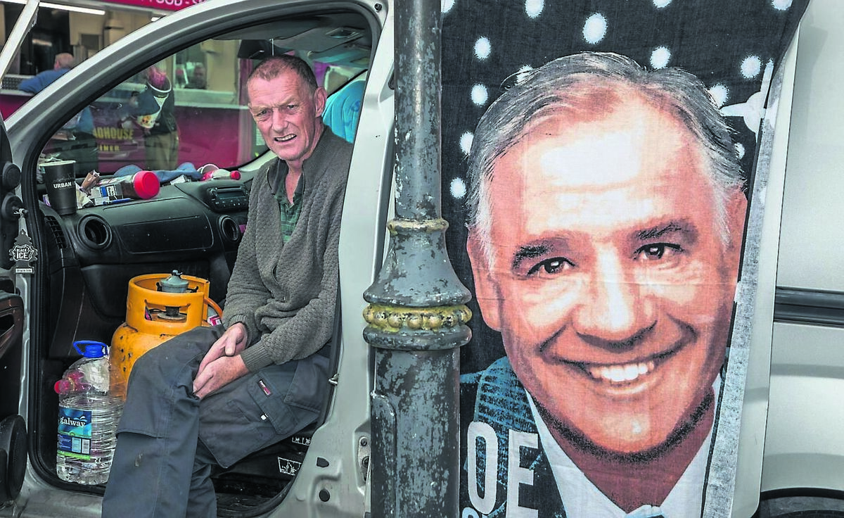 Kieran Desmond from Ballyvolane sits in his van as a bath towel with the image of Joe Dolan hangs off the door at the Ballabuidhe Festival in Dunmanway, Co. Cork.	 Picture: David Creedon
                    