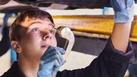 male apprentice mechanic with female mentor