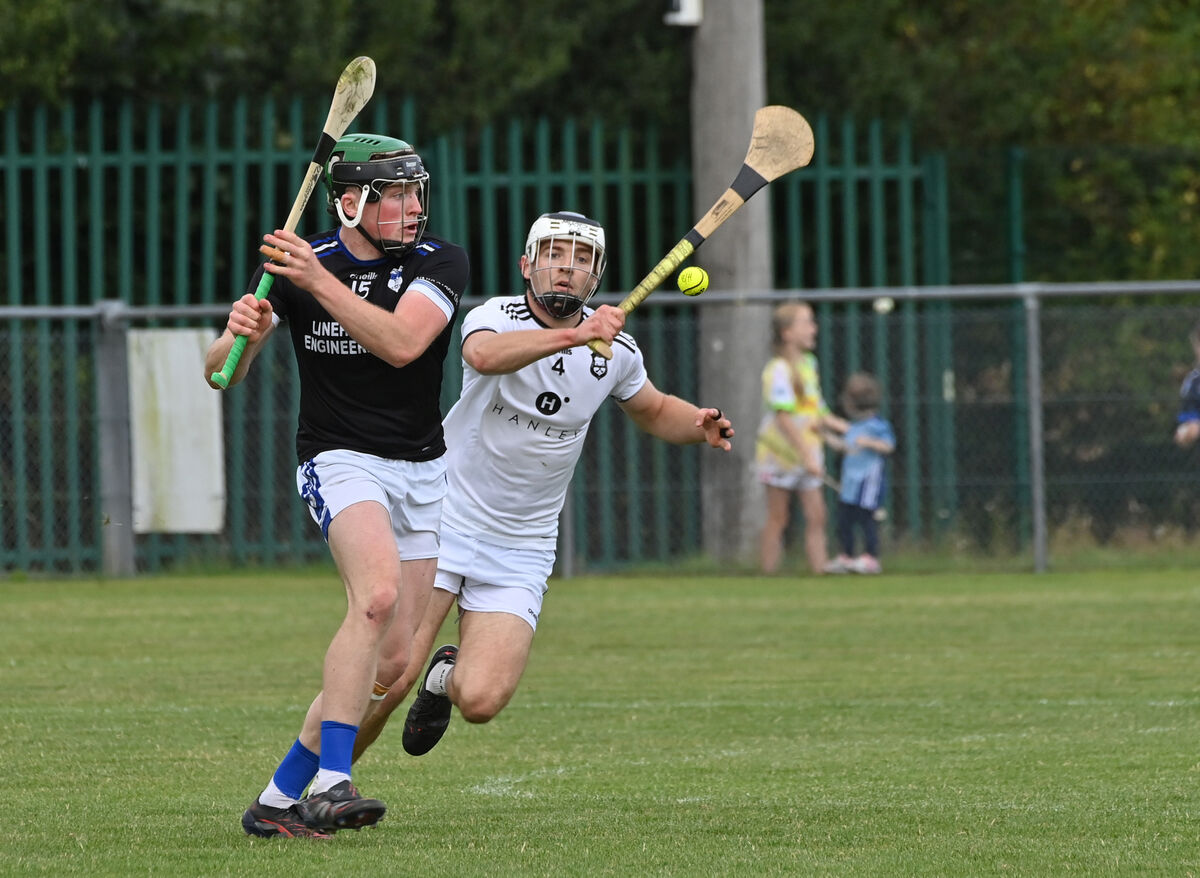  Padraig Holland of Inniscarra takes a shot on goal watched by William Carroll's Ballyhea in ther SAHC game at Mourneabbey. Picture: Dan Linehan