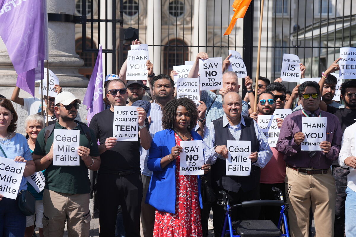 People take part in a silent assembly for migrant workers and their families outside the Department of the Taoiseach in Dublin, following the recent attacks on members of the Indian community.