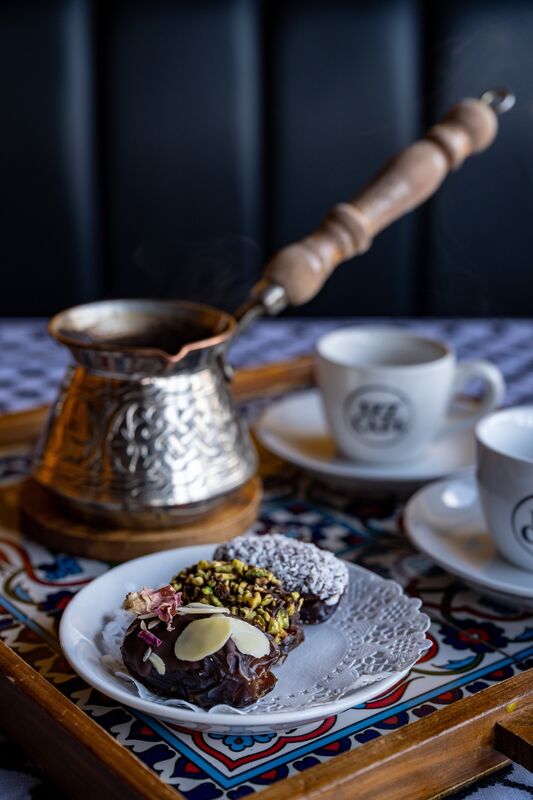 A tray of traditional Palestinian coffee served alongside dates, showcasing the authentic way to enjoy the rich flavours, at Izz Alkarajeh’s cafe in Cork City. Picture Chani Anderson.