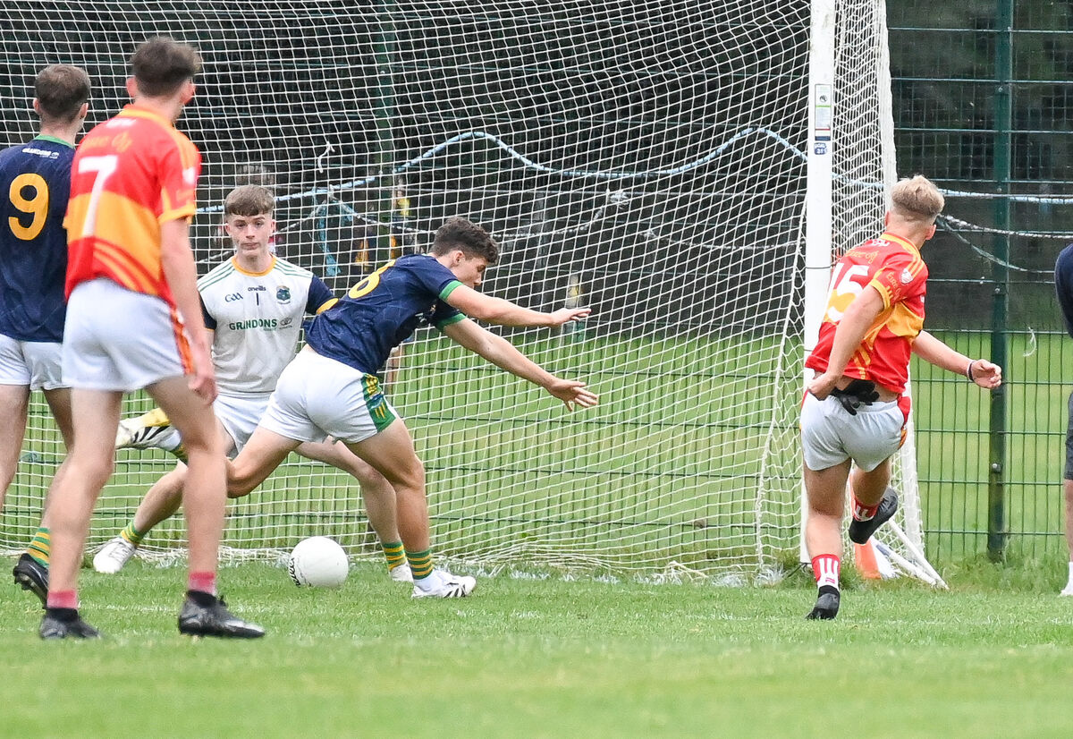 Éire Óg's Darragh Sheehan crashes the ball to the Glanmire net past Isaac Barrett. Picture: David Keane. Éire Óg's Darragh Sheehan crashes the ball to the Glanmire net past Isaac Barrett. Picture: David Keane.