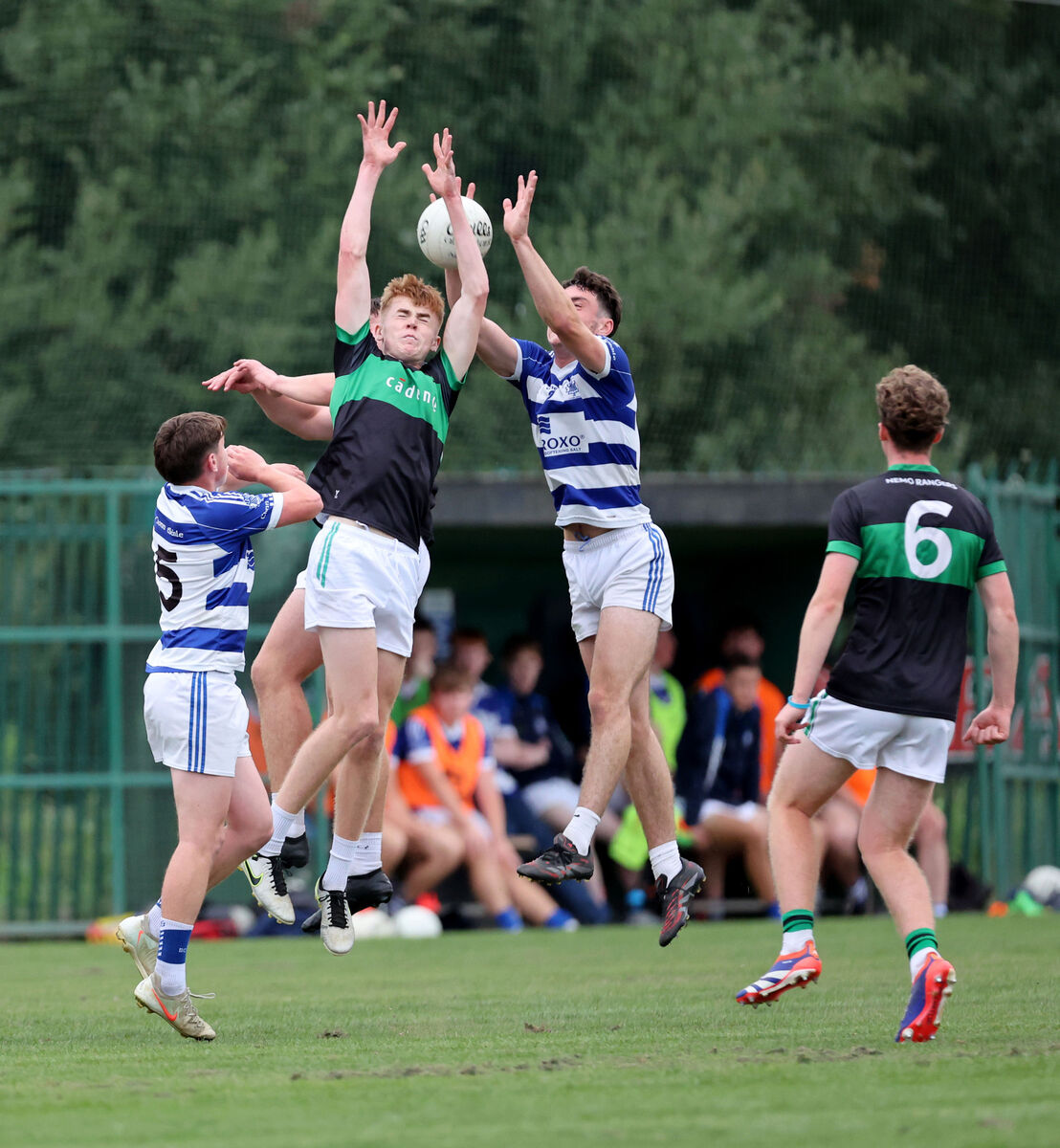 Matthew Keenan and Larry Butler, Nemo Rangers, battle for the high ball with Ben Long, Kinsale. Matthew Keenan and Larry Butler, Nemo Rangers, battle for the high ball with Ben Long, Kinsale.