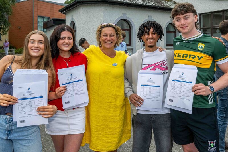  Bandon Grammar School students met in the courtyard of the school to share their results with their classmates. The German class of 2025 Belle O'Brien; Sarah Lane; Cian Sheridan and Tadhg Ó Conchúir with their subject teacher Rachel Darby. Picture: Andy Gibson.