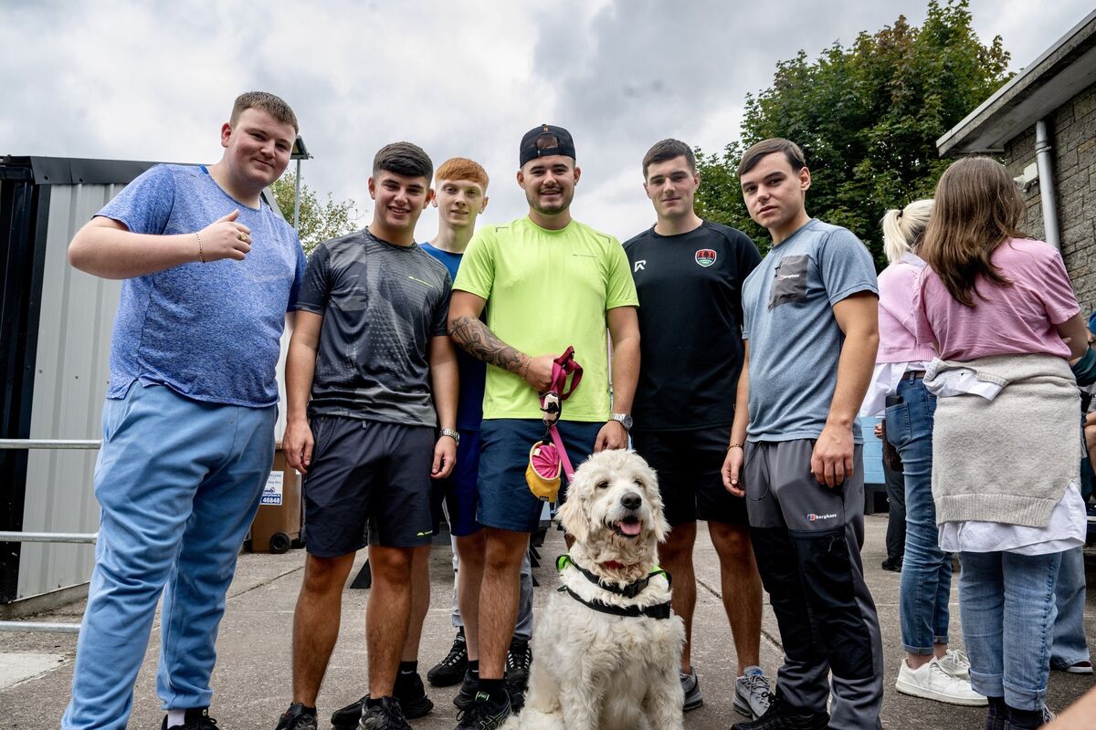 Leaving Cert students enjoy the company of Cora, the school dog, at the Coláiste Éamonn Rís summer barbecue, a companion they will miss as they move on. Picture Chani Anderson