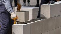 The bricklayer is working. Building a wall of aerated concrete. Gasbeton wall