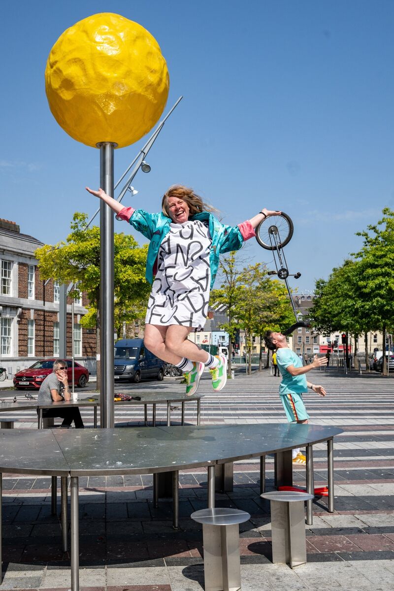 Noelle O’Regan leaps into the air on the Coal Quay as her husband, Cormac Mohally, performs in the background as they prepare for next month’s Uptown Circus Festival. Picture: Chani Anderson Noelle O’Regan leaps into the air on the Coal Quay as her husband, Cormac Mohally, performs in the background as they prepare for next month’s Uptown Circus Festival. Picture: Chani Anderson