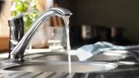 Water running from tap into kitchen sink