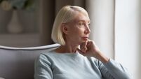 Pensive middle-aged woman look in distance thinking