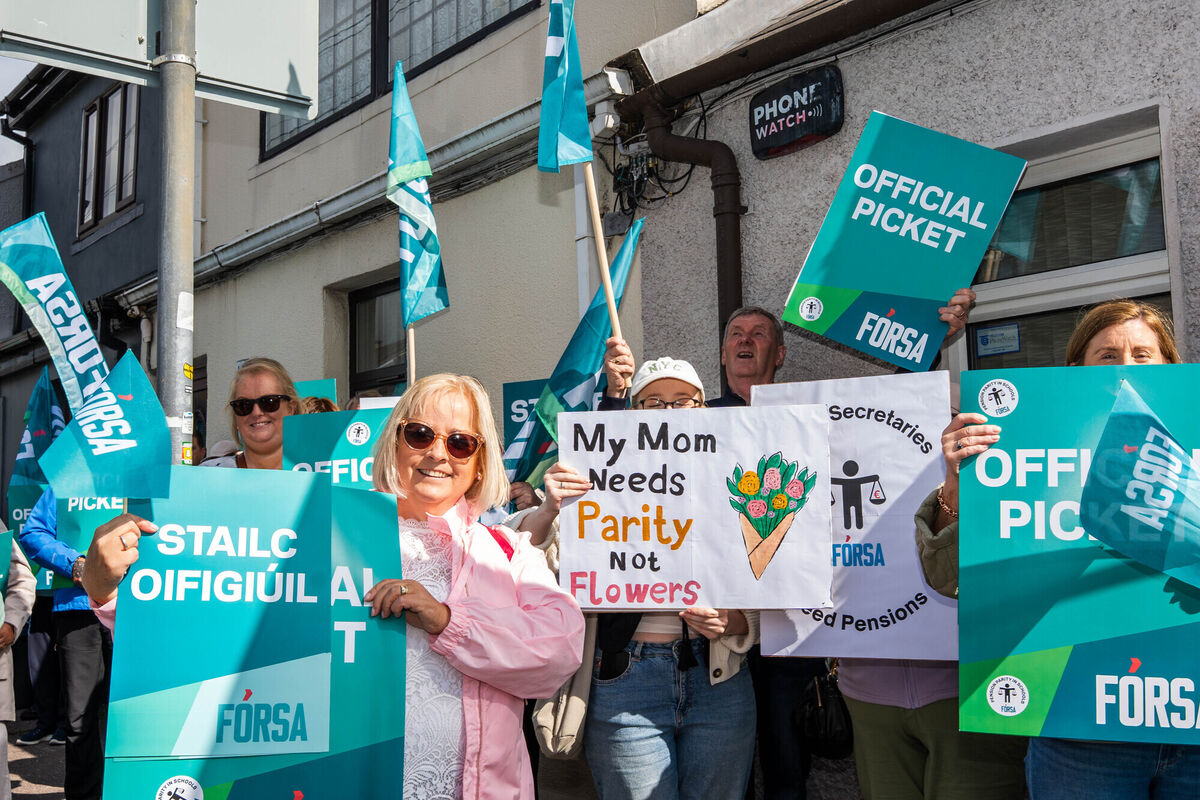 Protesters hold up signs outside An Taoiseach Micheál Martin's constituency office in Turners Cross. Picture: Noel Sweeney. Protesters hold up signs outside An Taoiseach Micheál Martin's constituency office in Turners Cross. Picture: Noel Sweeney.