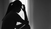 Young  women sitting in dark room feeling pain with life problem.  suffering from husband violence, Stop violence against and se
