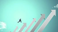 businessman jumping on growing chart with sky background