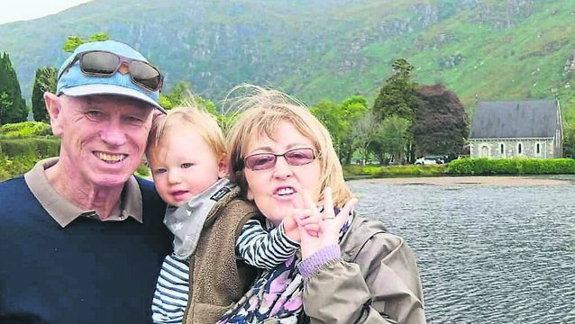 <p class="contextmenu internal_Caption">Sheila Wilson at Gougane Barra on a trip home to Cork last summer, with her husband Maurice and their grandson Cooper. Sheila was born and raised in the Muskerry Gaeltacht in the 1950s, and grew up on a farm with six siblings, their parents, and grandmother</p>