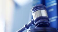 Gavel In Front Of Row Of Law Books